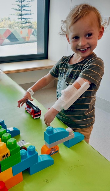 Ruben smiling and playing while receiving hospital treatment
